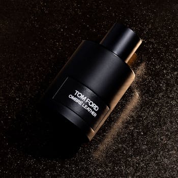Inicio Elegant image of Tom Ford Ombre Leather fragrance bottle against a textured dark background.